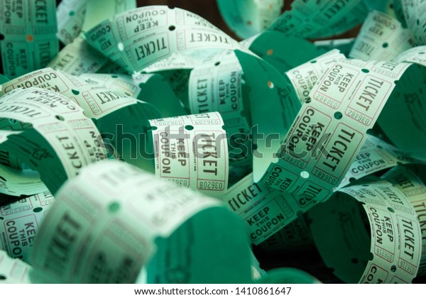 unrolled roll of green\
raffle tickets
