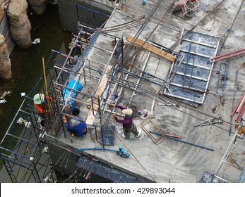 Unsafe Construction Site. The worker is working in construction site without proper safety equipment.