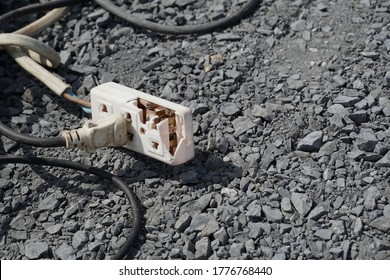 Unsafe Workplace, Plug In Broken Socket On Ground Floor. Concept Of Unsafe Workplace, Socket Plug, Hazards, Risk, Dangerous, Shot Circuit, Risk Work, Unsafe Work, Hazards.                          