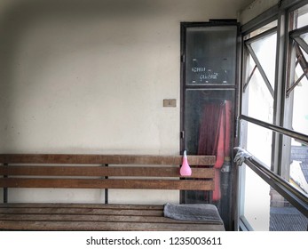 Unsafely Condition Of Firefighter Equipment In The Old Building, The Wooden Long Chair Is Blocked The Door. “Only Firefighter Equipment” Is The Words On The Glass Door, Copy Spaces