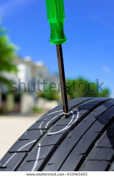unscrew from car tyre,\
damaged car tyre