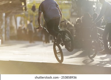 Unseen Bmx Rider Balancing On One Wheel
