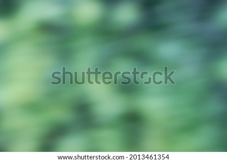 Unsharp image of green leaves for background work. Unclear background for graphic work. Background work consisting of green leaves and tones of green color.