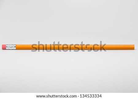 Unsharpened yellow pencil isolated on white background