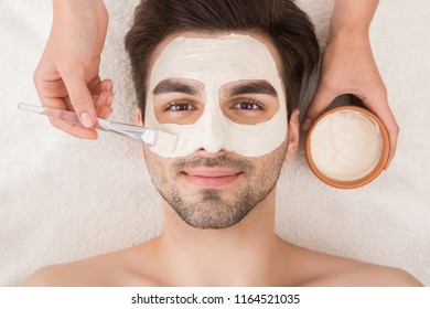 Unshaven Man Having Cosmetic Mask In Spa Salon, Top View