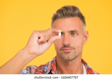 Unshaven Man Hold Vitamin Pill, Selective Focus. Medicine Concept. Anabolic And Steroids. Food Additives For Male Health. Bio Vitamin Complex. Disease Treatment. Presenting Product. Man Look At Drug.