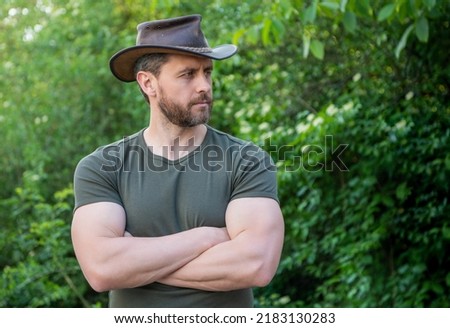 unshaven man wearing cowboy hat. caucasian man in hat. macho man