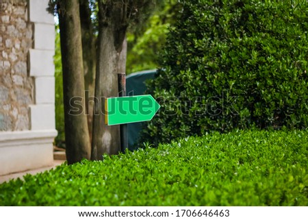 unsigned isolated signpost surrounded by grass