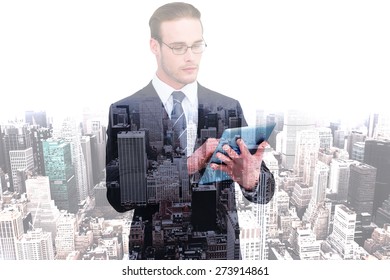 Unsmiling businessman using tablet pc against high angle view of city - Powered by Shutterstock