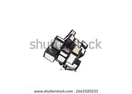 An unsolved Mirror Cube puzzle, a variation of the classic Rubik's Cube, is centered on a pure white background. 