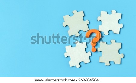 Unsolved Problem or Missing Piece concept with a question mark and four jigsaw puzzle pieces, symbolizing a search for answers and mystery.
