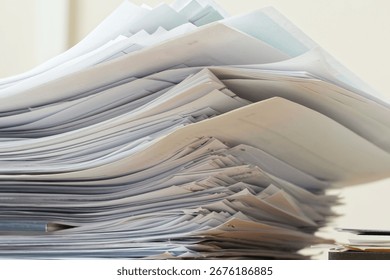 Unsorted heap of files and sheets, representing office work, red tape, record keeping and administrative chaos. Photo