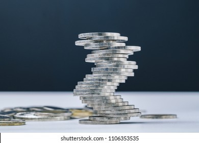 Unstable Closed To Collapse Stack Of Coins Tower , Uncertainty Of Business, Risk Of Financial Or Investment, No Stability, Problem Or Crisis Concept.