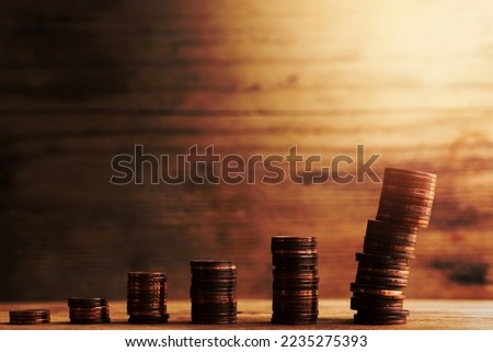 Unstable stacks of small value copper euro coins depicting a bar graph. Concept of a financial unsteadiness and risk of losing money.