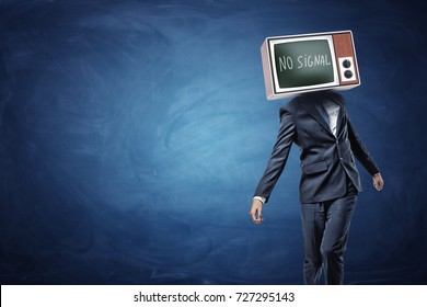 An unsteady businessman on blue background with a TV replacing his head and showing black screen and No Signal writing. No original thoughts. No brainer job. Business manipulation.