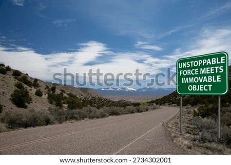 unstoppable force meets immovable object highway sign desert road mountains