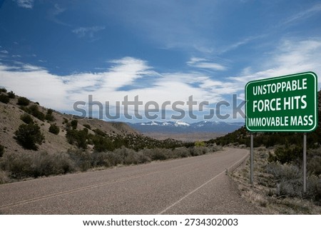 unstoppable force meets immovable object highway sign desert road mountains