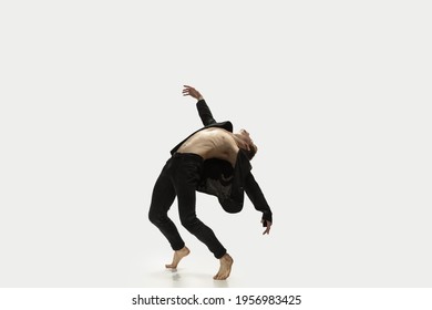 Unstoppable. Man in casual style clothes jumping and dancing isolated on white background. Art, motion, action, flexibility, inspiration concept. Flexible caucasian ballet dancer, weightless jumps.
