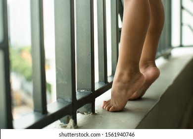 Unsupervised Toddler Climbing A Dangerous High Balcony Railing. Risky Child Behavior. Fatal Accidents. 