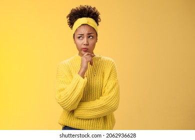 Unsure hesitant worried cute african-american girl face tough decision look up thoughtful make plan thinking how act right touch chin, make assumption standing concerned yellow background