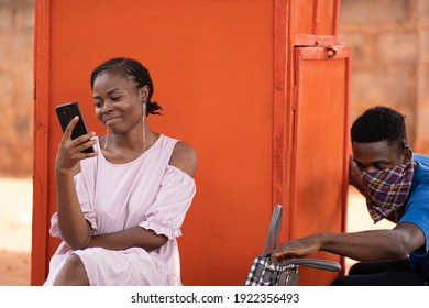 Unsuspecting Young Black Woman Using Her Phone As Someone Tries To Steal From Her Bag