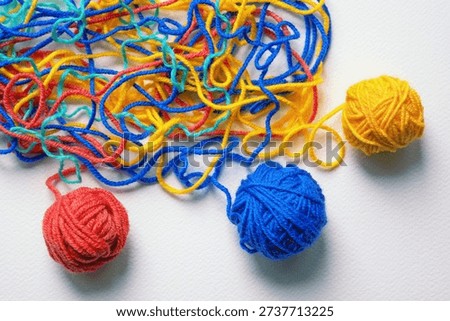 Untangling tangled threads as concept of problem solution. Colorful tangled wool threads and winding them into balls. Copy space.