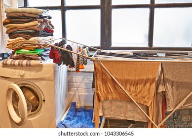 Untidy And Messy Male Laundry Room Against Windows