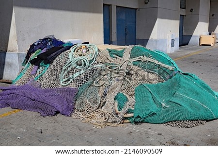 An untidy pile of fishing nets at the edge of the beach in Estepona in Spain