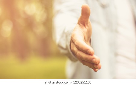 Until Next Time. Young Man In Standing In Park Stretches His Hand. Focus Is On Hand. Close Up.