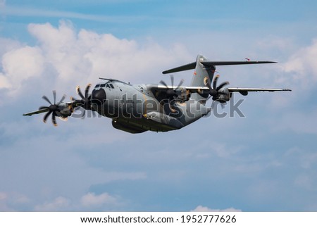 Untitled airplane. Military transport plane. Aircraft without title at airport. Aviation theme. In flight. Flying.