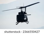 Untitled military helicopter at air base. Air force and army flight transportation. Aviation and rotorcraft. Transport and airlift. Military industry. Fly and flying. Commercial theme.