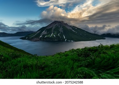 Untouched pristine nature of Onekotan Island, small volcanic island in the Sea of Okhotsk, part of Kuril chain of islands. Krenitsyn volcano is in the center of caldera lake. - Shutterstock ID 2075242588