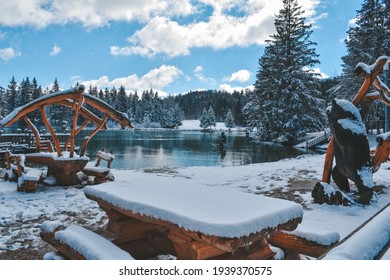 Untouched snow covering tables and benches on the shore of Lake Bloke, Slovenia - Shutterstock ID 1939370575