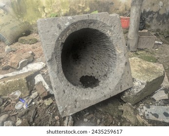 Unused ancient stone mortar lying on the ground, photo of ancient object, traditional equipment for pounding rice - Powered by Shutterstock