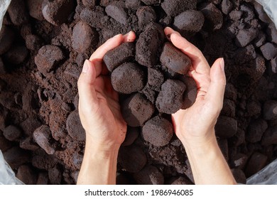 Unused coffee grounds with male hand. - Shutterstock ID 1986946085