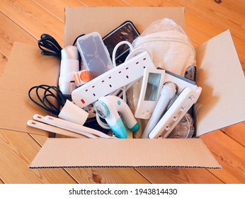 Unused items in the cardboard box. - Shutterstock ID 1943814430