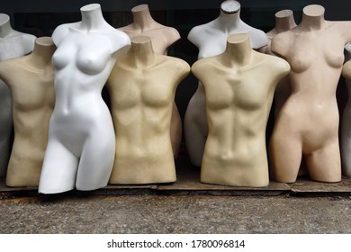 Unused Mannequin Body. Mannequins In Second Hand Shop Front. The Scrap Of Cloth Model At The Street Fashion Store For Sale.