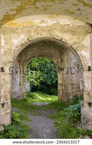 An unusual arched through passage into the rooms of an old ruined church. Copy space. Selective focus.