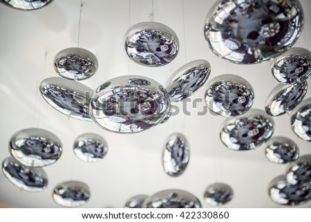 unusual chandelier, metal changing balls, interior