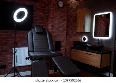 unusual interior tattoo salon with a bright design and comfortable black chairs for customers