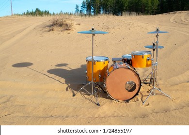 Unusual Location Selected For A Musical Instrument. Drum Set In The Sand.