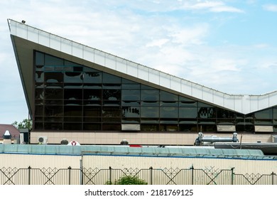 An Unusual Office Building Made Of Glass And Concrete With An Uneven Angular Roof. Modern Futuristic Design Of The Building Of The Future.