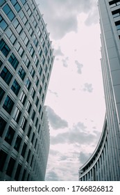 Unusual Perspective On A Corporate Building In Moscow. Bottom View Of A Geometric White Business Center With Blue Windows. Corporate Buildings Concept. Moscow Business And Business District.