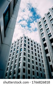 Unusual Perspective On A Corporate Building In Moscow. Bottom View Of A Geometric White Business Center With Blue Windows. Corporate Buildings Concept. Moscow Business And Business District.