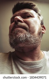 Unusual Portrait Of An Adult Bearded Man. 44 Year Old Man With Beard Grimaces In Front Of Camera. Close-up. Selective Focus.