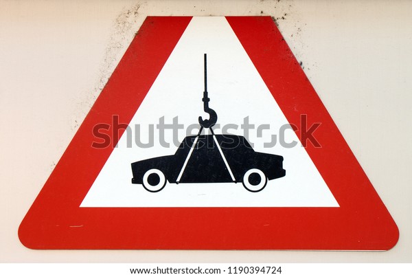 unusual street sign with\
car on the hook