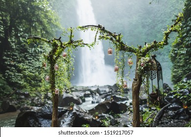 Unusual Wedding Ceremony Arch With Waterfall View In Jungle Rainforest. Dream Wedding Ceremony In Bali.