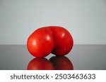 unusually and odd shaped tomato with reflection.