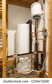 Unvented Hot Water Cylinder And Expansion Vessel In An Airing Cupboard. UK Plumbing