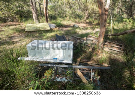 Unwanted refridgerator and other household furnature dumped illegally in the Australian bush.